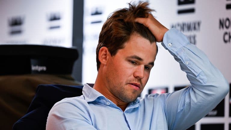 Chess grandmaster Magnus Carlsen rejoins tournament he quit over wearing jeans – after dress code change